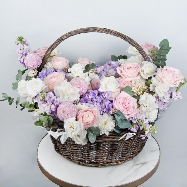 Baltica White Spray Chrysanthemum - 2, Ranunculus Pink - 5, Peony rose pink 'OHara' - 15, Blue/purple hydrangea - 3, lisianthus - 4, Matthiola Lilac - 5, Momoko Chrysanthemum - 3, Medium Basket, Oasis, Ozotamnus, Eucalyptus
