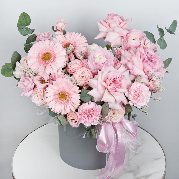 Gerbera pink - 7, Peony rose pink 'OHara' - 3, Ranunculus Pink - 3, Peony sprayrose - 3, Pink carnation - 13, Pink Lisianthus (Eustoma) - 2, Round flower box medium, Oasis, Eucalyptus, Ribbon, Limonium (1 pc.)