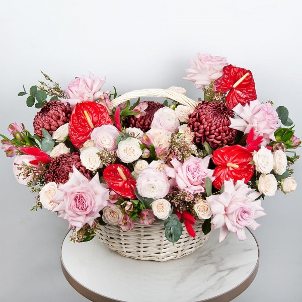 Red cut anthurium - 4, Chrysanthemum Bigoudi purple - 4, Peony style roses - 7, Ranunculus Pink - 5, Alstromeria white, soft pink - 19, Peony sprayrose - 5, Medium Basket, Oasis, Waxflower (1 pc.), Eucalyptus, Dried flowers in assortment