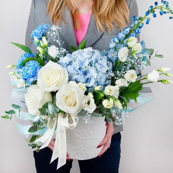 Blue/purple hydrangea - 2, Blue carnation - 4, White rose 50 cm - 4, lisianthus - 4, Colored gypsophila - 1, Round flower box small , Oasis, Wrapping Paper, Ruscus, Eucalyptus Cinerea, Blue Delphinium