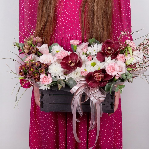 Pink Cymbidium Orchid Bud - 3, Pink Lisianthus (Eustoma) - 3, Pink spray carnation - 5, White Delphinium - 2, Bacardi White Spray Chrysanthemum - 1, Baltica White Spray Chrysanthemum - 1, Wooden pot, Oasis, Wrapping Paper, Flask for orchids, Eucalyptus, Genista