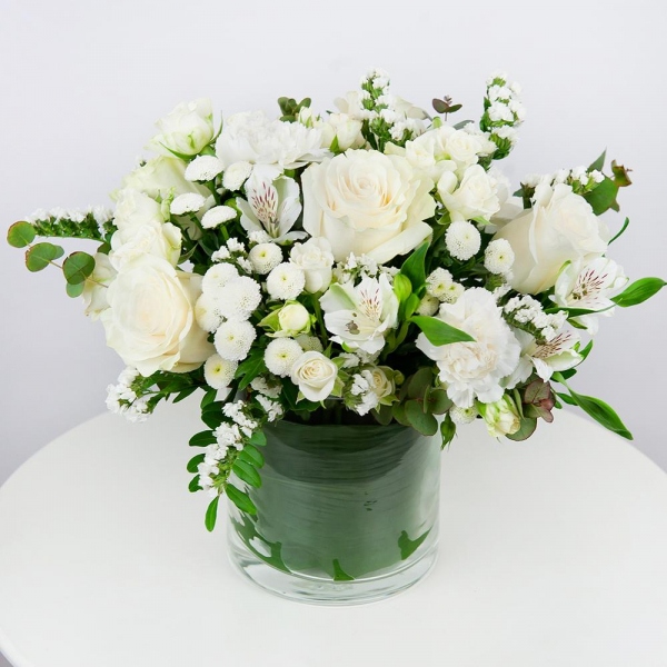 White rose 50 cm - 4, Spray rose: white, cream, light pink 50 cm - 3, Carnation white, cream - 3, Alstromeria white, soft pink - 2, Santini White Spray Chrysanthemum - 4, Transparent vase, Oasis, White statice, Pistachio, Eucalyptus Cinerea