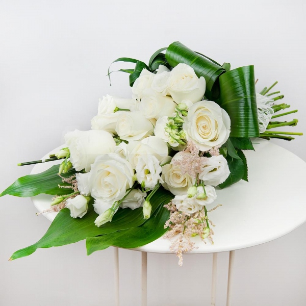 White rose 50 cm - 16, lisianthus - 8, Astilbe, Aspidistra (1 pc.), Ribbon