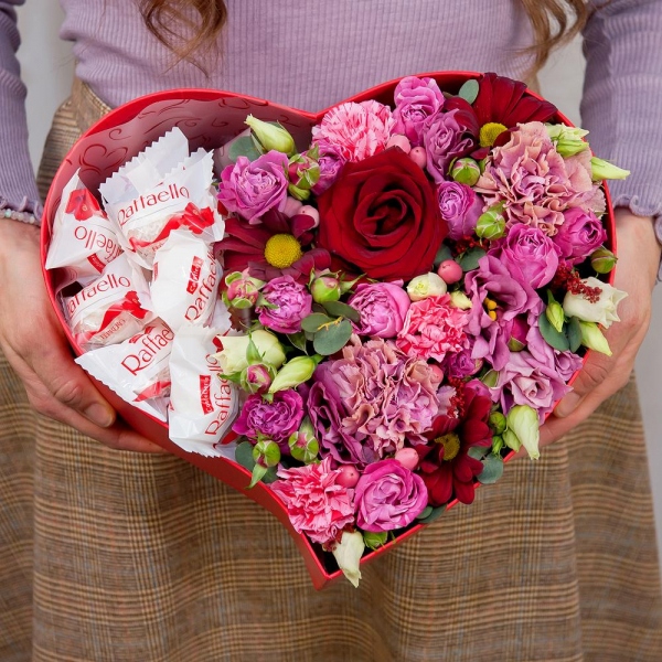 Red rose 50 cm - 2, Pink carnation - 3, Pink spray carnation - 2, Pink Lisianthus (Eustoma) - 1, Bacardi Red Spray Chrysanthemum - 2, Bright pink spray rose mix, 50 cm - 3, Heart‑shaped box for arrangements, Oasis, Film, Box of candies «Raffaello» 150 g, Hypericum, Eucalyptus Cinerea