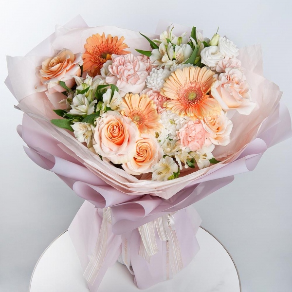 Cream gerbera - 3, Baltica White Spray Chrysanthemum - 2, Carnation white, cream - 15, Pink-orange rose Phoenix 50 cm - 5, Alstromeria white, soft pink - 7, lisianthus - 2, Wrapping Paper