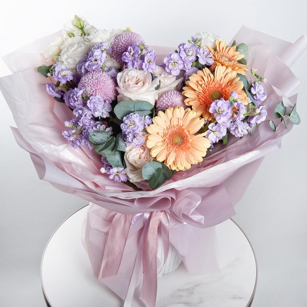 Cream gerbera - 11, Peony style roses - 3, Momoko Chrysanthemum - 3, Matthiola Lilac - 5, lisianthus - 5, Eucalyptus, Wrapping Paper