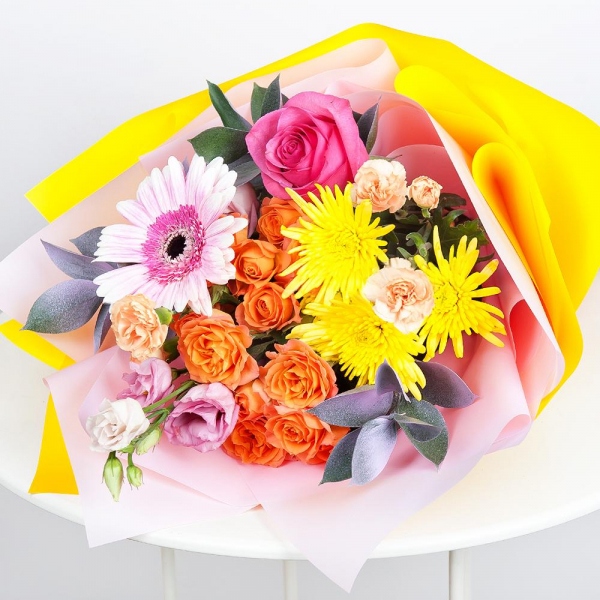 Spray rose: yellow, orange 50 cm - 3, Pink spray carnation - 3, Baltica Yellow Spray Chrysanthemum - 3, Pink Lisianthus (Eustoma) - 4, Gerbera pink - 2, Pink rose 50 cm - 3, Ruscus, Wrapping Paper