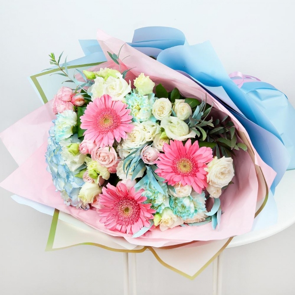 Blue/purple hydrangea - 1, Gerbera pink - 6, Blue carnation - 7, Spray rose: white, cream, light pink 50 cm - 5, lisianthus - 4, Aspidistra (1 pc.), Eucalyptus, Wrapping Paper