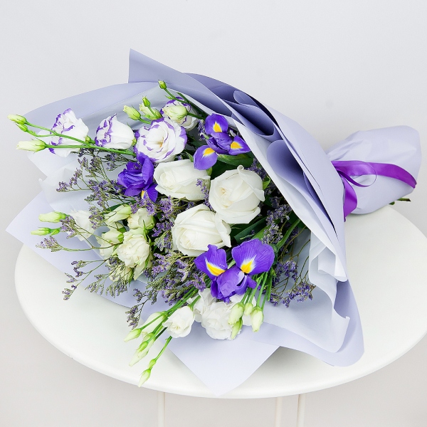 Irises - 5, lisianthus - 1, White rose 50 cm - 5, Spray rose: white, cream, light pink 50 cm - 3, Purple Lisianthus (Eustoma) - 2, Limonium (1 pc.), Wrapping Paper