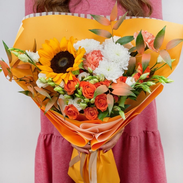 Sunflower - 3, Orange carnation - 3, lisianthus - 4, Baltica White Spray Chrysanthemum - 2, Spray rose: yellow, orange 50 cm - 4, Ruscus italian, Ribbon, Wrapping Paper
