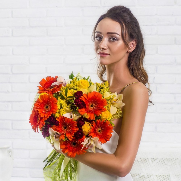 Gerbera daisies - 11, White Cymbidium Orchid Bud - 11, Spray rose: red 50 cm - 10, Yellow rose 50 cm - 7, Flask for orchids, Solidago (1 pc.), Pistachio, Mesh (Abaka), Ribbon