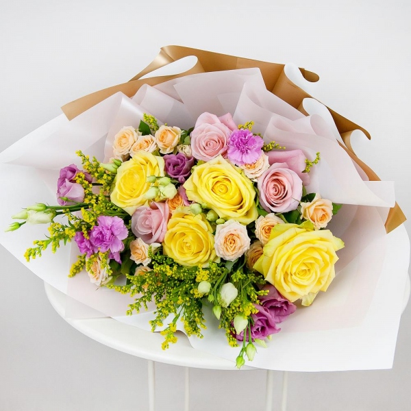 Yellow rose 50 cm - 5, Pink rose 50 cm - 4, Spray rose: white, cream, light pink 50 cm - 4, Pink spray carnation - 4, Pink Lisianthus (Eustoma) - 2, Solidago (1 pc.), Wrapping Paper