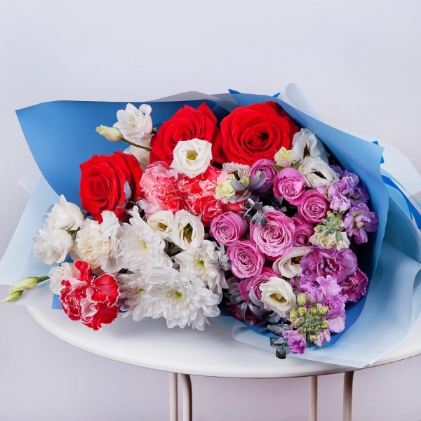 Baltica White Spray Chrysanthemum - 2, Peony sprayrose - 2, Red rose 50 cm - 5, Carnation red - 3, Matthiola Lilac - 2, lisianthus - 2, Carnation spray - 3, Carnation white, cream - 2, Pistachio, Wrapping Paper, Ribbon