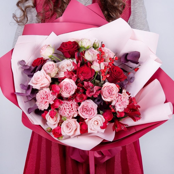 Spray rose: red 50 cm - 4, Peony sprayrose - 2, Pink carnation - 4, Alstromeria Red, Bright Pink - 2, Red rose 50 cm - 5, Pink rose 50 cm - 5, Ilex, Eucalyptus Cinerea, Wrapping Paper, Ribbon