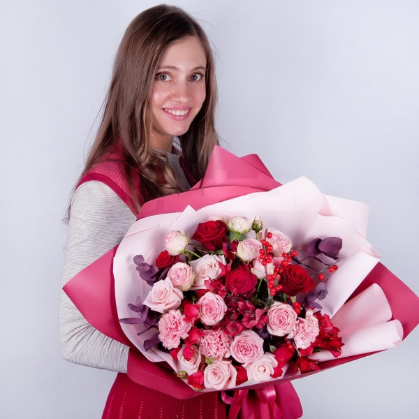 Spray rose: red 50 cm - 4, Peony sprayrose - 3, Pink carnation - 5, Alstromeria Red, Bright Pink - 3, Red rose 50 cm - 5, Pink rose 50 cm - 6, Ilex, Eucalyptus Cinerea, Wrapping Paper, Ribbon
