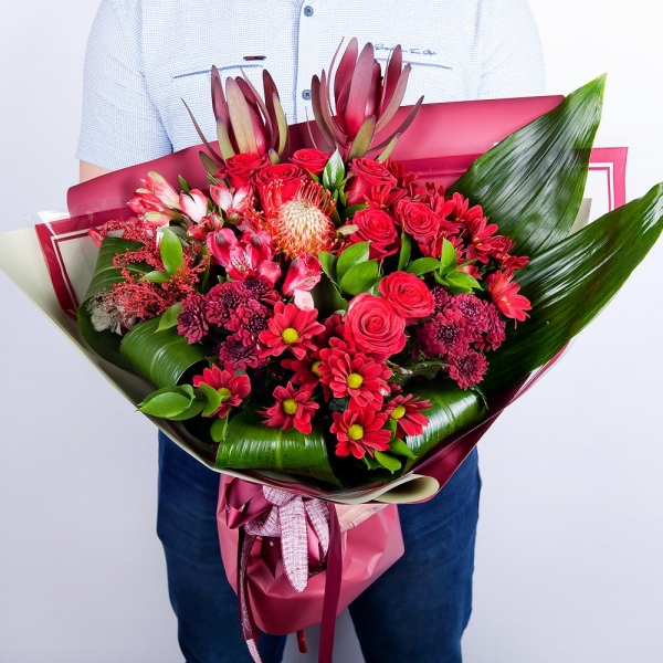 Bacardi Red Spray Chrysanthemum - 3, Red rose 50 cm - 10, Alstromeria Red, Bright Pink - 4, Daisy poms Santini pink, purple - 3, Leukodendron, Aspidistra (1 pc.), Solidago (1 pc.), Wrapping Paper, Ribbon, Ruscus, Nutan