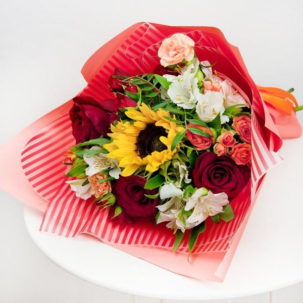 Sunflower - 1, Alstromeria white, soft pink - 4, Spray rose: red 50 cm - 2, Pink spray carnation - 2, Red rose 50 cm - 3, Spray rose: yellow, orange 50 cm - 2, Pistachio, Wrapping Paper