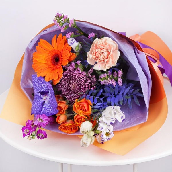 Chrysanthemum Bigoudi purple - 1, Spray rose: yellow, orange 50 cm - 2, Carnation white, cream - 3, Matthiola Lilac - 2, Gerbera daisies - 1, Vanda Orchid bud - 2, Purple Lisianthus (Eustoma) - 2, Flask for orchids, Pistachio, Wrapping Paper, Pink Statice