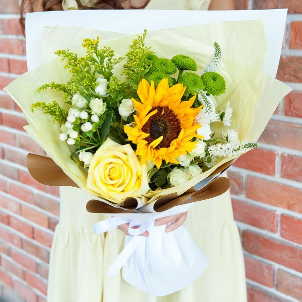 Sunflower - 1, Yellow rose 50 cm - 2, Spray rose: white, cream, light pink 50 cm - 3, Athos poms Green Lizard - 2, Santini White Spray Chrysanthemum - 2, Solidago (1 pc.), Hypericum, Veronica spray, Pistachio, Wrapping Paper