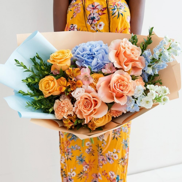 Blue/purple hydrangea - 1, Cream Rose 50 cm Ecuador (Creme Caramel) - 4, Rose Cream 50 cm - 5, Spray rose: white, cream, light pink 50 cm - 3, Carnation white, cream - 7, Alstromeria Yellow, Orange - 4, Alstromeria white, soft pink - 3, Blue Delphinium, Pistachio, Wrapping Paper
