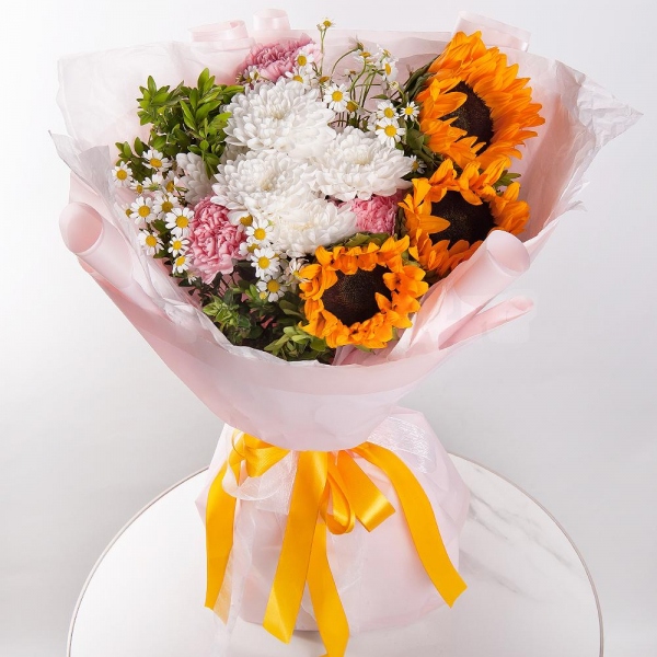 Sunflower - 3, Baltica White Spray Chrysanthemum - 1, Chamomile - 3, Pink carnation - 5, Pistachio, Wrapping Paper