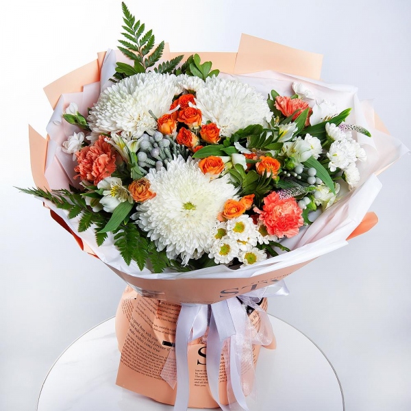 Magnum White Chrysanthemum - 3, Santini White Spray Chrysanthemum - 4, Spray rose: yellow, orange 50 cm - 3, Orange carnation - 5, White spray carnation - 5, Alstromeria white, soft pink - 5, Fern (1 pc.), Pistachio, Brunia Green Lanuginosa (1 pc.), Veronica spray, Wrapping Paper